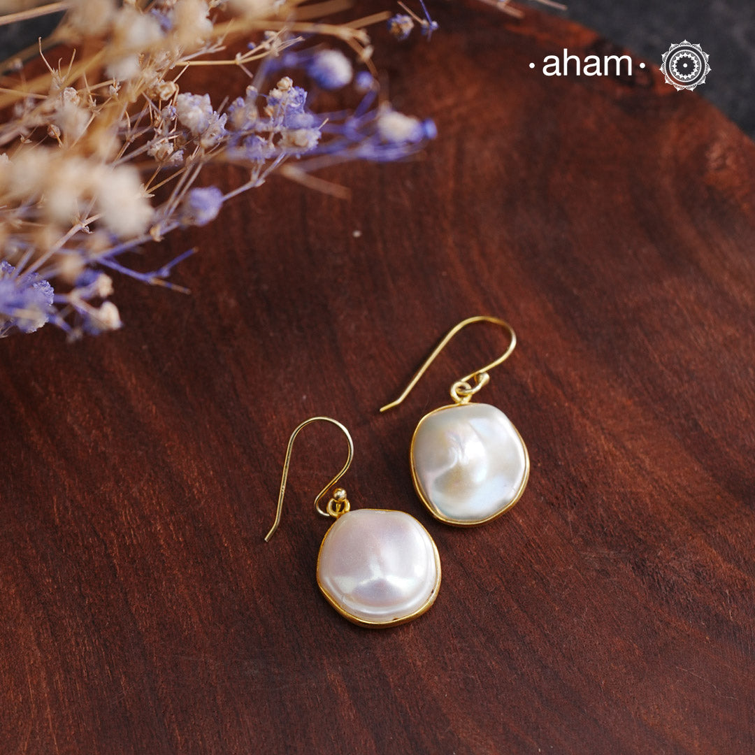 Shimmer and shine with these Mother of Pearl Gold Polish Silver Earrings! The natural mother of pearl is set in stylish silver with a touch of gold polish. The easy fishhook makes them light weight and a perfect go-to for any outfit. Dress them up or down, they'll be your new fave!

Keep in mind that these are natural forms, so both earrings in the set will have a similar shape, but not an exact match.