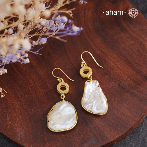 Shimmer and shine with these Mother of Pearl Gold Polish Silver Earrings! The natural mother of pearl is set in stylish silver with a touch of gold polish. The easy fishhook makes them light weight and a perfect go-to for any outfit. Dress them up or down, they'll be your new fave!

Keep in mind that these are natural forms, so both earrings in the set will have a similar shape, but not an exact match.