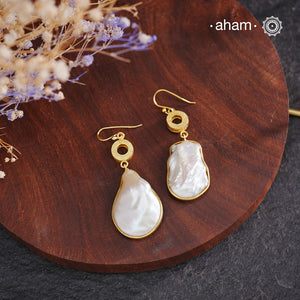 Shimmer and shine with these Mother of Pearl Gold Polish Silver Earrings! The natural mother of pearl is set in stylish silver with a touch of gold polish. The easy fishhook makes them light weight and a perfect go-to for any outfit. Dress them up or down, they'll be your new fave!