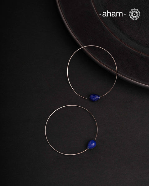 Contemporary light weight hoops in 92.5 silver with a lapiz drop for a hint of colour. Minimalist work wear jewellery. Perfect wear from Dawn to Dusk.