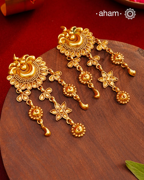 Handcrafted 92.5 Silver Earrings with antique Gold Polish Handcrafted with precision and timeless elegance in mind, these 92.5 silver earrings are carefully adorned with an antique gold polish. The result is a stunning and sophisticated piece of jewelry that will elevate any outfit, making you stand out with its unique charm