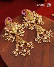 Feel like royalty when dressed in these Paisley Gold Polish Silver Earrings.&nbsp;Crafted using traditional techniques in 92.5 sterling silver with gold polish, semi precious stones and cultured pearls. A perfect wear with your traditional sarees and lehengas for intimate weddings and upcoming festive celebrations.