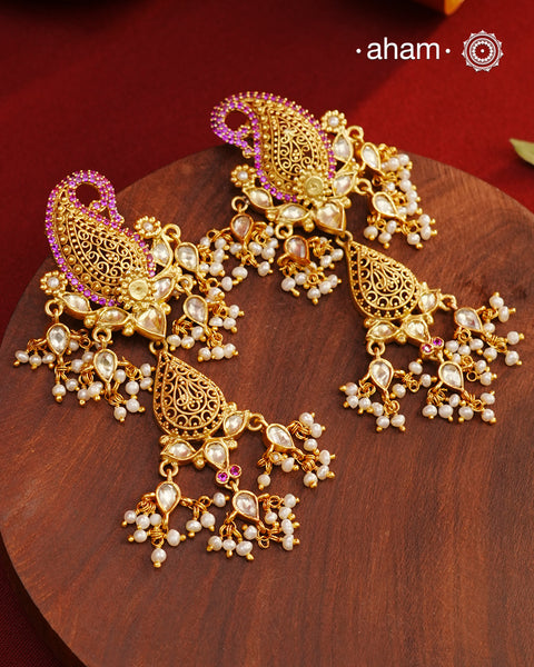 Feel like royalty when dressed in these Paisley Gold Polish Silver Earrings.&nbsp;Crafted using traditional techniques in 92.5 sterling silver with gold polish, semi precious stones and cultured pearls. A perfect wear with your traditional sarees and lehengas for intimate weddings and upcoming festive celebrations.