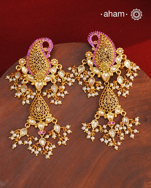Feel like royalty when dressed in these Paisley Gold Polish Silver Earrings.&nbsp;Crafted using traditional techniques in 92.5 sterling silver with gold polish, semi precious stones and cultured pearls. A perfect wear with your traditional sarees and lehengas for intimate weddings and upcoming festive celebrations.