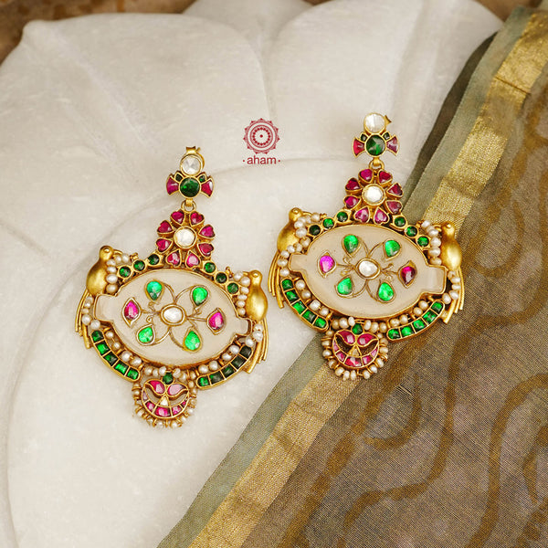 Fine Kundan work Earrings with delicate work and center stone setting with inlay work. Crafted in finest silver with gold polish, these are heirloom earrings that can be passed on for generations to come. 