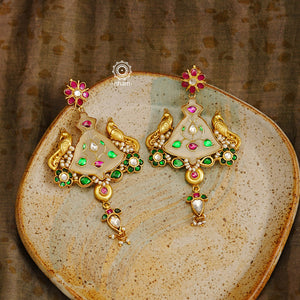 Fine Kundan work Earrings with delicate work and center stone setting with inlay work. Crafted in finest silver with gold polish, these are heirloom earrings that can be passed on for generations to come. 
