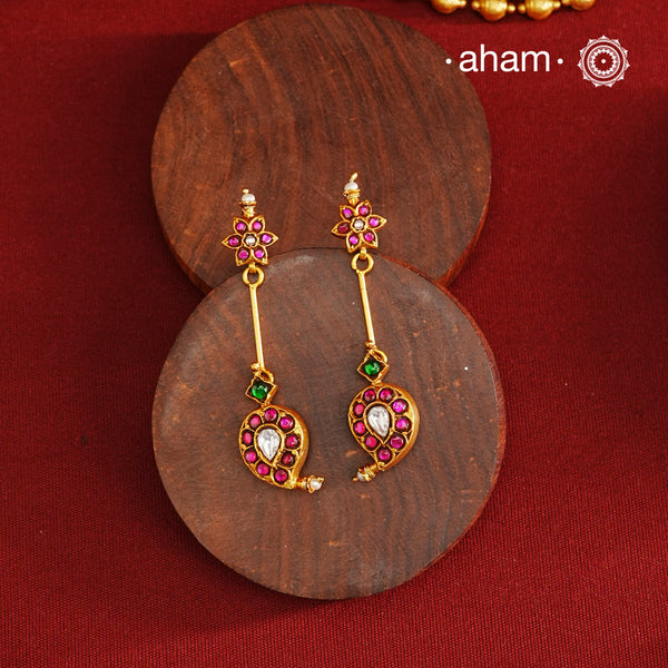 Handcrafted silver paisley earrings with gold polish and rani pink kundan work. Lightweight dainty earrings perfect for special occasions and upcoming festivities.