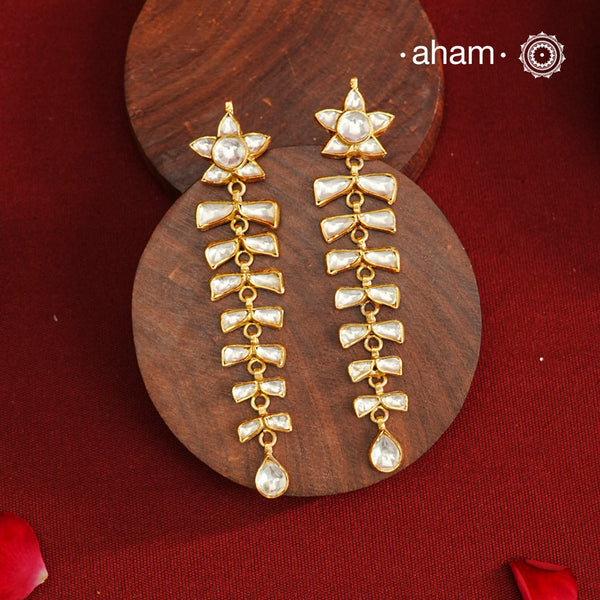These long shoulder duster earrings feature an elegant cascading design, expertly crafted in 92.5% silver with a refined gold polish. The intricate kundan setting adds a traditional touch, making them an exquisite choice for festive occasions and parties. Their lightweight construction ensures comfortable wear while making a striking statement. Perfect for elevating your evening attire with a blend of classic craftsmanship and contemporary style.