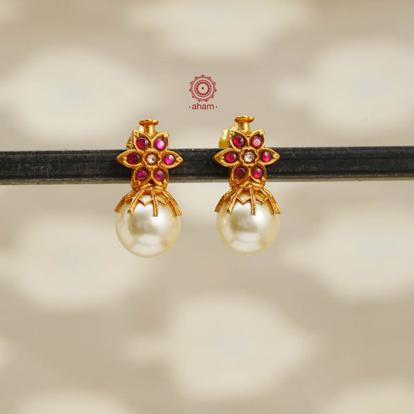 Handcrafted golden glow pearl drop silver earrings with gold polish and flower stud in rani pink setting. Lightweight earrings perfect for special occasions and gifting.