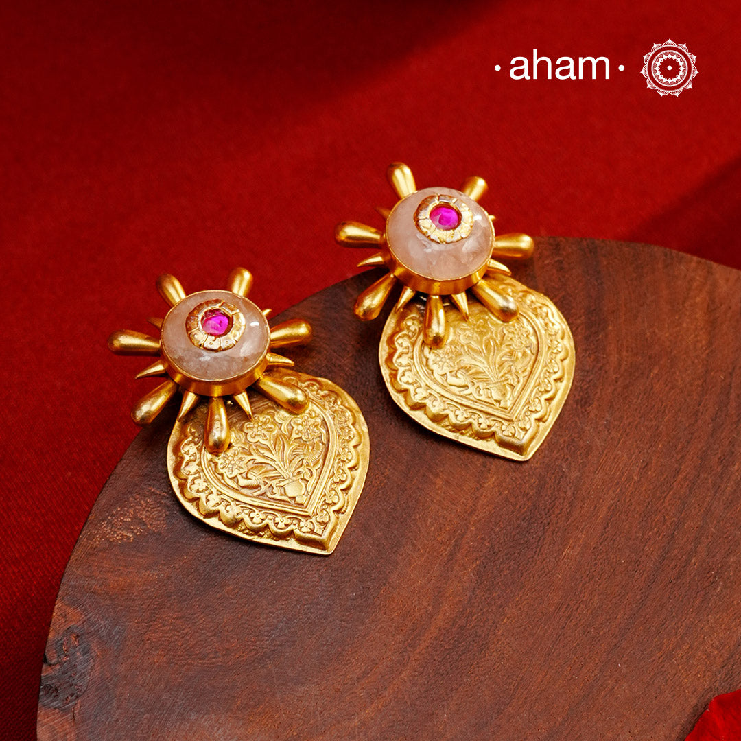 Exude elegance when dressed in these gold polish silver earrings with rose quartz stone. Crafted using traditional techniques in 92.5 sterling silver with intricate floral work. Perfect for intimate weddings and upcoming festive celebrations.