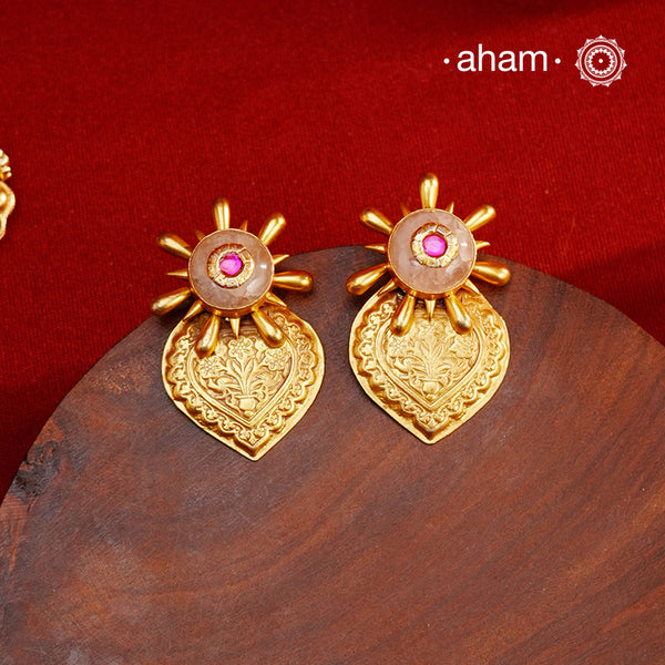 Exude elegance when dressed in these gold polish silver earrings with rose quartz stone. Crafted using traditional techniques in 92.5 sterling silver with intricate floral work. Perfect for intimate weddings and upcoming festive celebrations.