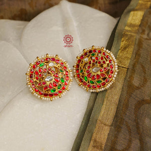 Feel like royalty when dressed in these gold polish peacock studs. Elegant earrings handcrafted in 92.5 sterling silver with deep red coloured kundan work. This pair is perfect for special occasions and festivities.