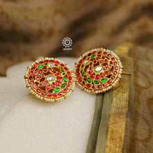 Feel like royalty when dressed in these gold polish peacock studs. Elegant earrings handcrafted in 92.5 sterling silver with deep red coloured kundan work. This pair is perfect for special occasions and festivities.