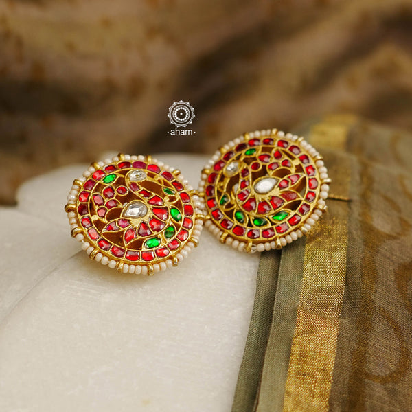 Feel like royalty when dressed in these gold polish peacock studs. Elegant earrings handcrafted in 92.5 sterling silver with deep red coloured kundan work. This pair is perfect for special occasions and festivities.