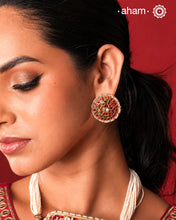 Feel like royalty when dressed in these gold polish peacock studs. Elegant earrings handcrafted in 92.5 sterling silver with deep red coloured kundan work. This pair is perfect for special occasions and festivities.