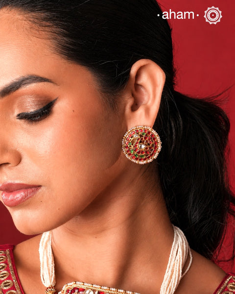 Feel like royalty when dressed in these gold polish peacock studs. Elegant earrings handcrafted in 92.5 sterling silver with deep red coloured kundan work. This pair is perfect for special occasions and festivities.