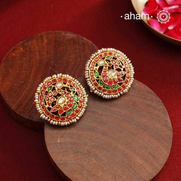 Feel like royalty when dressed in these gold polish peacock studs. Elegant earrings handcrafted in 92.5 sterling silver with deep red coloured kundan work. This pair is perfect for special occasions and festivities.