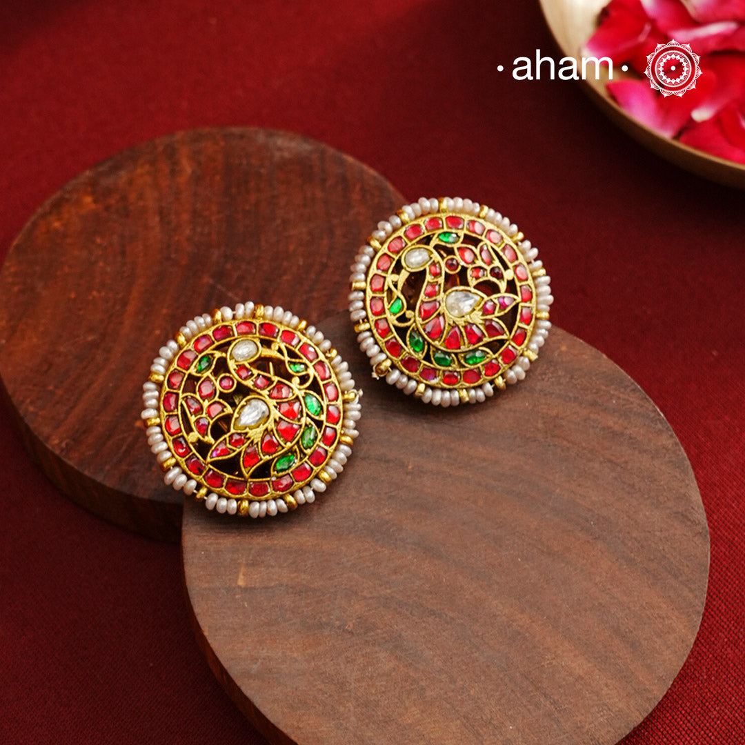 Feel like royalty when dressed in these gold polish peacock studs. Elegant earrings handcrafted in 92.5 sterling silver with deep red coloured kundan work. This pair is perfect for special occasions and festivities.