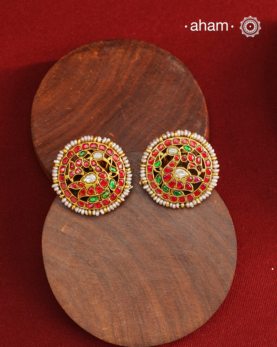 Feel like royalty when dressed in these gold polish peacock studs. Elegant earrings handcrafted in 92.5 sterling silver with deep red coloured kundan work. This pair is perfect for special occasions and festivities.