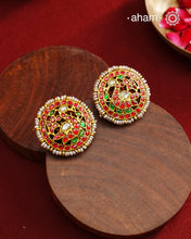 Feel like royalty when dressed in these gold polish peacock studs. Elegant earrings handcrafted in 92.5 sterling silver with deep red coloured kundan work. This pair is perfect for special occasions and festivities.