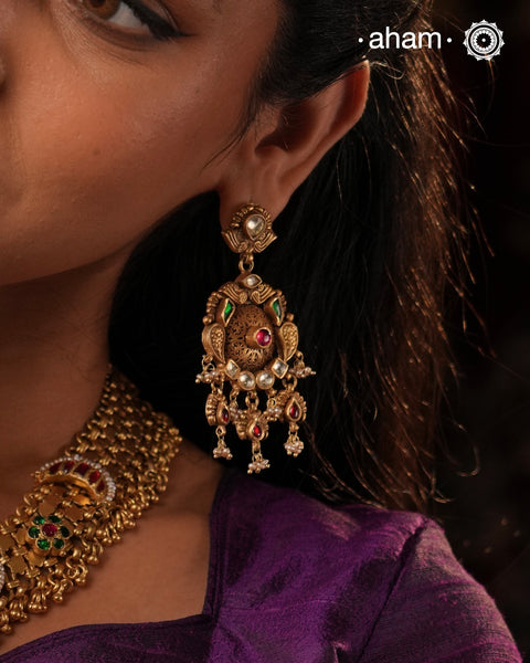 Add a touch of elegance to any outfit with these traditional chandelier-style Kundan gold polish silver earrings. Crafted with 92.5 silver and finished with gold polish, Kundan and pearl highlights, they are the perfect piece to go with any festive occasion.