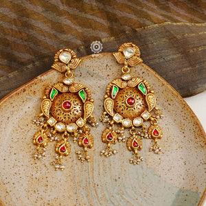 Add a touch of elegance to any outfit with these traditional chandelier-style Kundan gold polish silver earrings. Crafted with 92.5 silver and finished with gold polish, Kundan and pearl highlights, they are the perfect piece to go with any festive occasion.