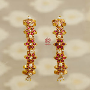 Statement gold polish earrings handcrafted using traditional techniques in silver with kundan work and dangling cultured pearls. Perfect for intimate weddings and upcoming festive celebrations.