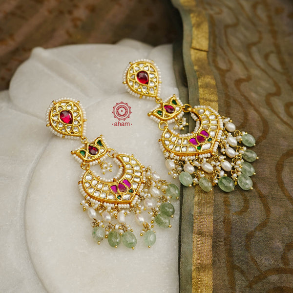 Statement gold polish chandelier earrings with elegant lotus motif. Handcrafted using traditional techniques in silver with kundan work and dangling cultured pearls. Perfect for intimate weddings and upcoming festive celebrations.