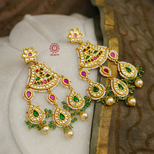 Statement gold polish chandelier earrings with elegant workmanship Handcrafted using traditional techniques in silver with kundan work and laced with pearls. Perfect for intimate weddings and upcoming festive celebrations.