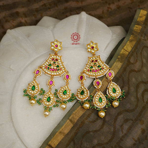 Statement gold polish chandelier earrings with elegant workmanship Handcrafted using traditional techniques in silver with kundan work and laced with pearls. Perfect for intimate weddings and upcoming festive celebrations.