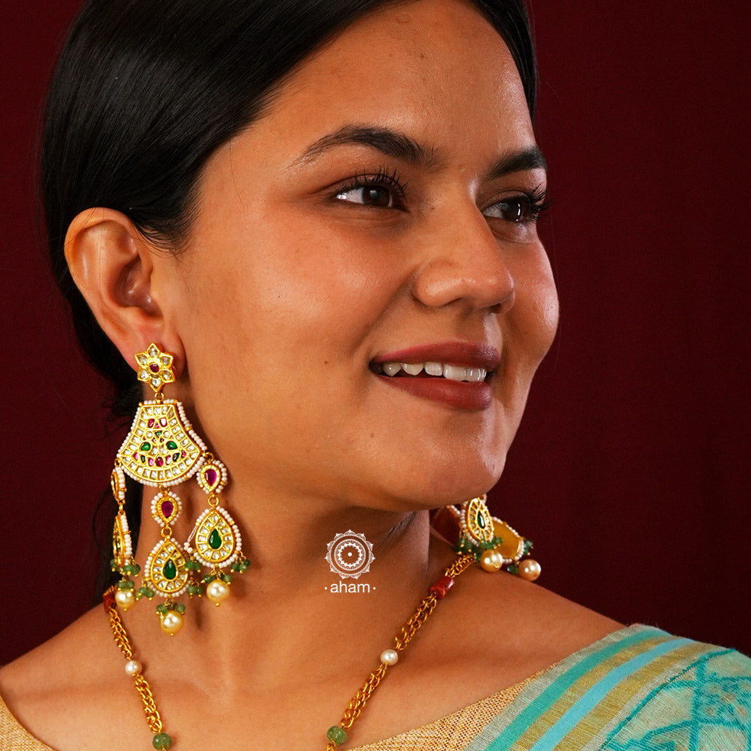 Statement gold polish chandelier earrings with elegant workmanship Handcrafted using traditional techniques in silver with kundan work and laced with pearls. Perfect for intimate weddings and upcoming festive celebrations.