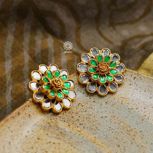 These unique handmade studs, crafted with 92.5 sterling silver and polished with gold, will add a touch of elegance to any outfit. The kundan studs have a beautiful green highlight that adds a festive element, and with their exclusive craftsmanship, these earrings will instantly elevate your look.