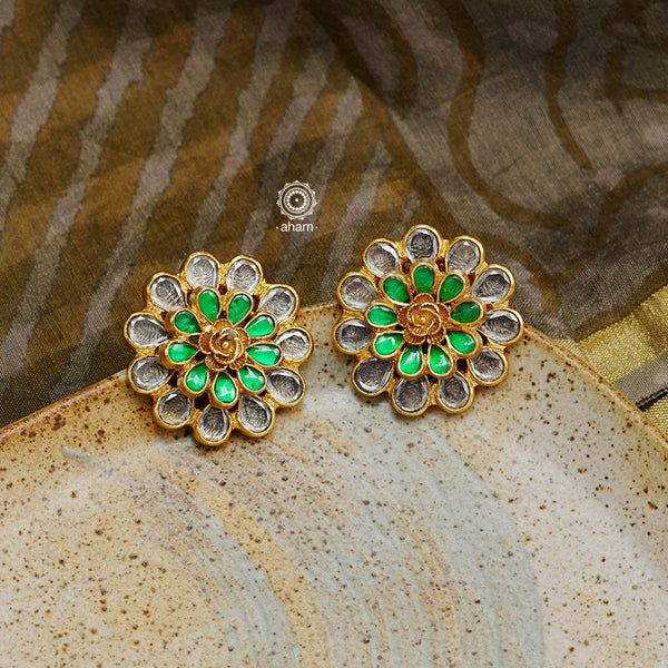 These unique handmade studs, crafted with 92.5 sterling silver and polished with gold, will add a touch of elegance to any outfit. The kundan studs have a beautiful green highlight that adds a festive element, and with their exclusive craftsmanship, these earrings will instantly elevate your look.