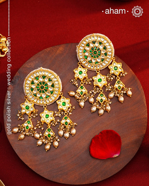 Elevate your style with our Festive Green Kundan Gold Polish Silver Earrings. These magnificent statement earrings feature detailed kundan work and delicate pearls, all crafted in 92.5 silver. These showstopper earrings are all you need for your next big occasion