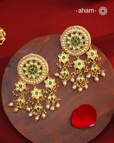 Elevate your style with our Festive Green Kundan Gold Polish Silver Earrings. These magnificent statement earrings feature detailed kundan work and delicate pearls, all crafted in 92.5 silver.&nbsp;These showstopper earrings are all you need&nbsp;for your next big occasion.