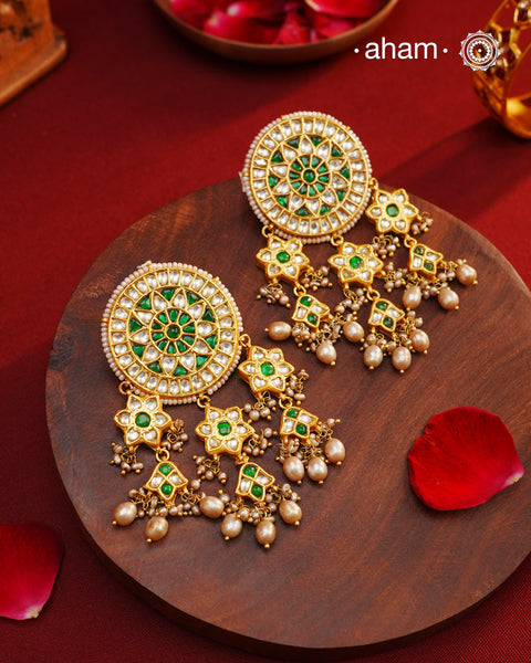 Elevate your style with our Festive Green Kundan Gold Polish Silver Earrings. These magnificent statement earrings feature detailed kundan work and delicate pearls, all crafted in 92.5 silver.&nbsp;These showstopper earrings are all you need&nbsp;for your next big occasion.