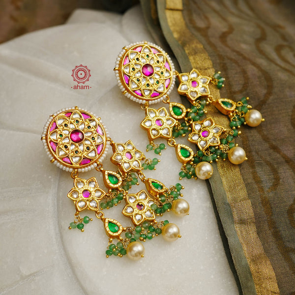 Statement gold polish earring with multiple mini dangling flowers. Handcrafted using traditional methods in 92.5 sterling silver with cultured pearls. Pair these with your ethnic outfits this festive season to ace your look.