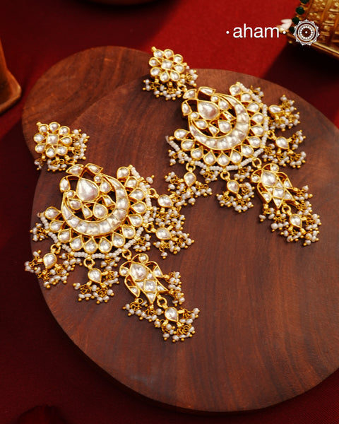 Statement gold polish chandbali earring with little hanging pearls. Handcrafted using traditional methods in 92.5 sterling silver and platted in gold. Pair these with your ethnic outfits this festive season to ace your look.