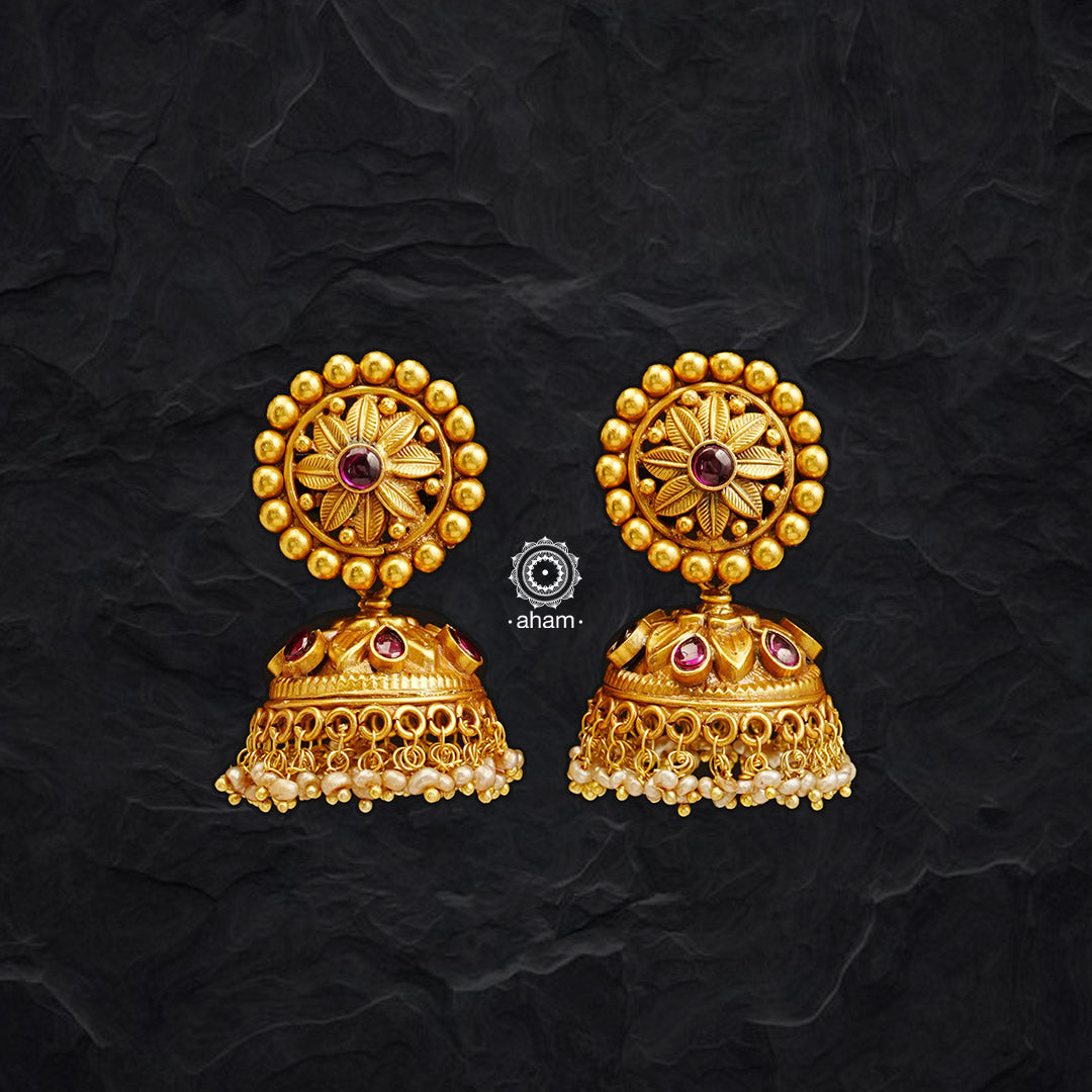These classic south style Flower Gold Polish Silver Jhumkies are crafted with 92.5 sterling silver and finished with gold polish, adding a touch of luxury to any ensemble. Detailed with elegant pearls, these jhumkies pair perfectly with your traditional wardrobe.