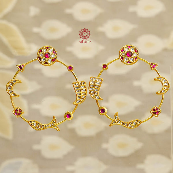 Add a touch elegance to your outfit with our statement Polish Silver Earrings. Featuring intricate kundan work and symbols of flowers, fish, moon, and tiger teeth, these 92.5 silver earrings are beautifully crafted and finished with a gold polish. Elevate your style with these unique and charming earrings.