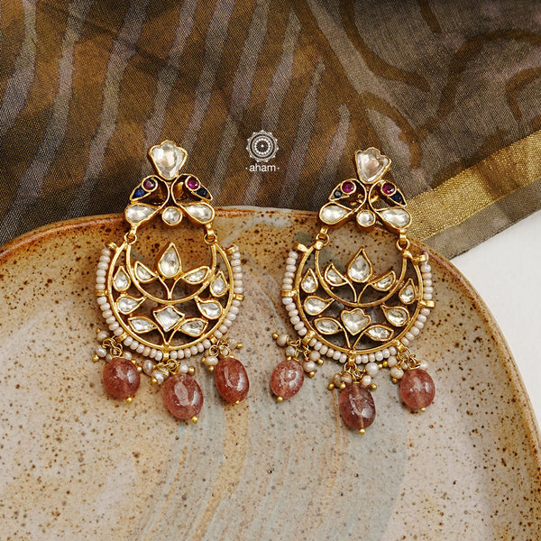 These unique Kundan Chandbali Earrings are handcrafted with 92.5 sterling silver and perfectly complemented with highlights of pearl and semi precious stones. Wear them to your next special event and make an unforgettable fashion statement.