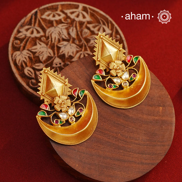 Classic diya earrings handcrafted from 92.5 sterling silver and adorned with kundan and rava work. The subtle dull gold polish adds a touch of elegance and beauty, making these the perfect accessory for any special occasion.
