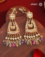 Crafted by master artisans in 92.5 silver, these Statement Chandbali Gold Polish Silver Earrings showcase magnificent Kundan work with stone drops fit for a queen. Perfect for grand celebrations, the intricate craftsmanship exudes regal elegance. Elevate any outfit with these stunning earrings.