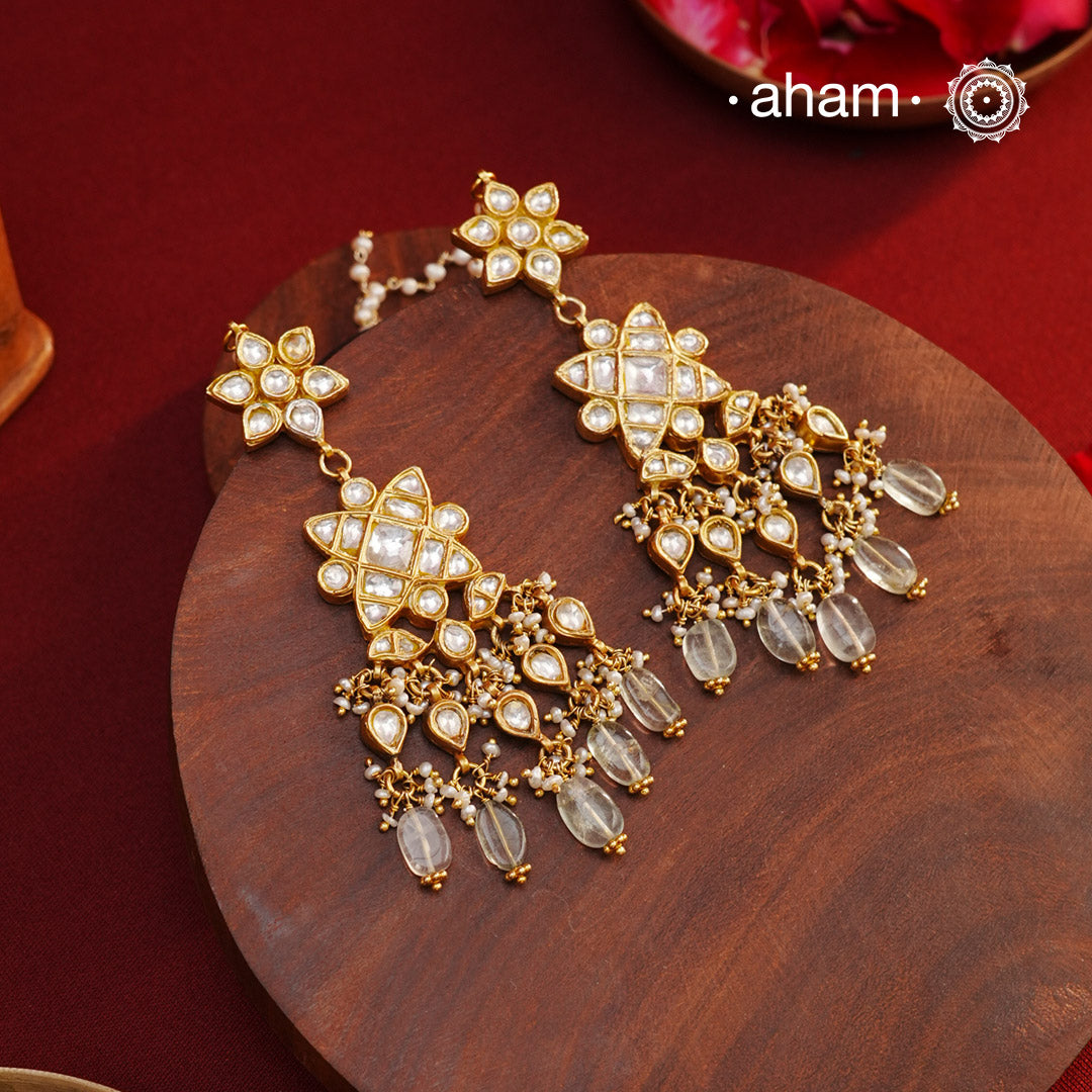 Statement gold polish earring with multiple mini danglers. Handcrafted using traditional methods in 92.5 sterling silver with cultured pearls. Pair these with your ethnic outfits this festive season to ace your look.