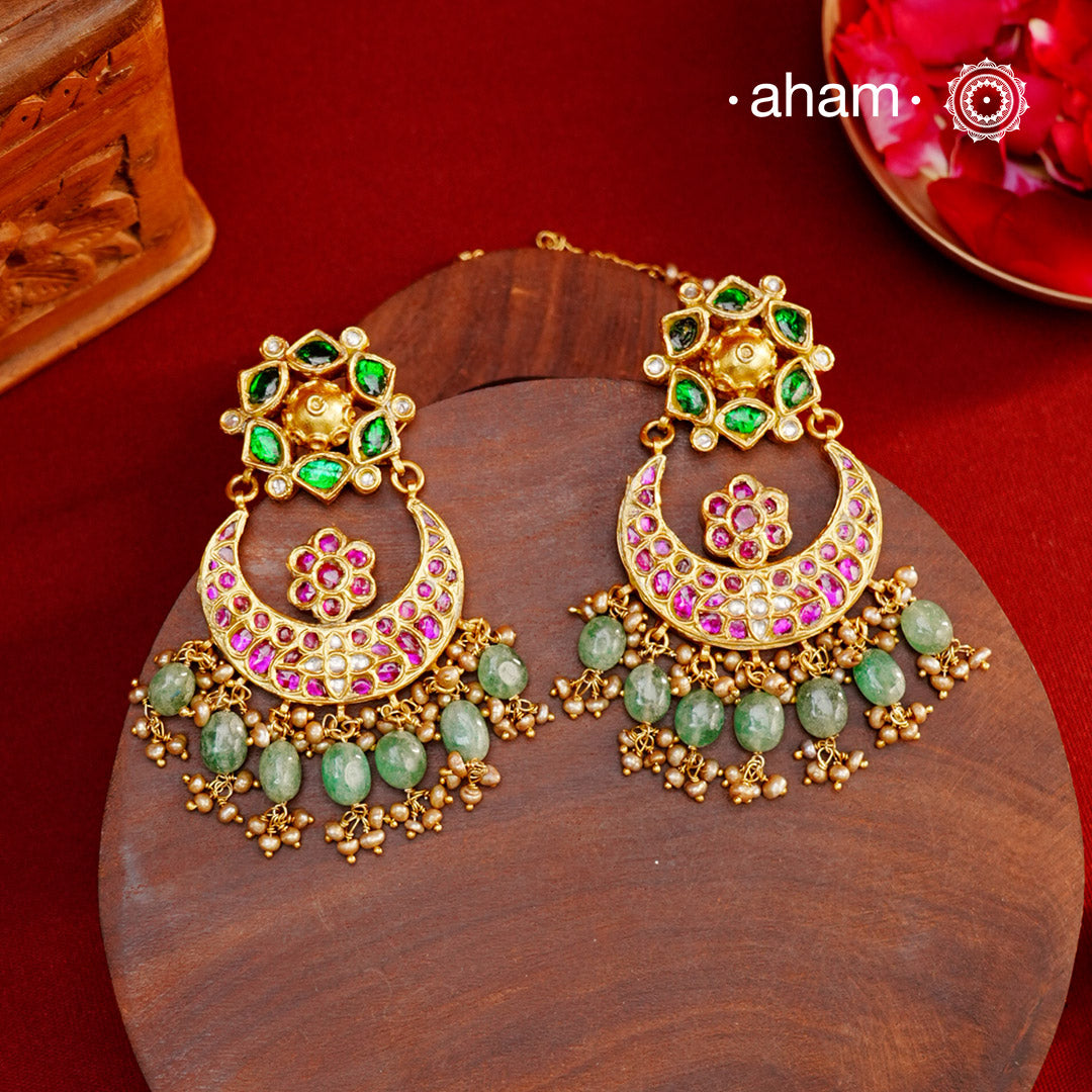 Crafted by master artisans in 92.5 silver, these Statement Chandbali Gold Polish Silver Earrings showcase magnificent Kundan work with stone drops fit for a queen. Perfect for grand celebrations, the intricate craftsmanship exudes regal elegance. Elevate any outfit with these stunning earrings.