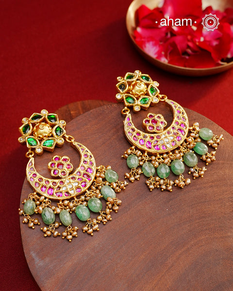 Crafted by master artisans in 92.5 silver, these Statement Chandbali Gold Polish Silver Earrings showcase magnificent Kundan work with stone drops fit for a queen. Perfect for grand celebrations, the intricate craftsmanship exudes regal elegance. Elevate any outfit with these stunning earrings.