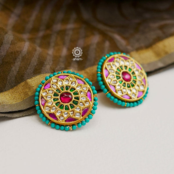Festive gold polish studs with vibrant floral work. Handcrafted in 92.5 sterling silver using jadau kundan techniques. Perfect for special occasions, pair these floral earrings with your favorite ethnic outfits.