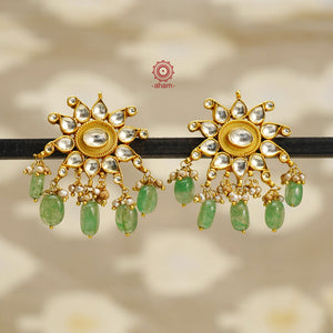 Feel like royalty when dressed in these kundan gold polish earrings. Handcrafted in 92.5 sterling silver with semi precious green beads and cultured pearls. Perfect for special occasions and festivities.