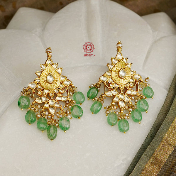 Delicate silver earrings with beautiful kundan work laced with green semi precious stones and pearls. Handcrafted using traditional methods in 92.5 sterling silver and dipped in 22 kt gold polish. Pair these with your ethnic outfits this festive season to ace your look.