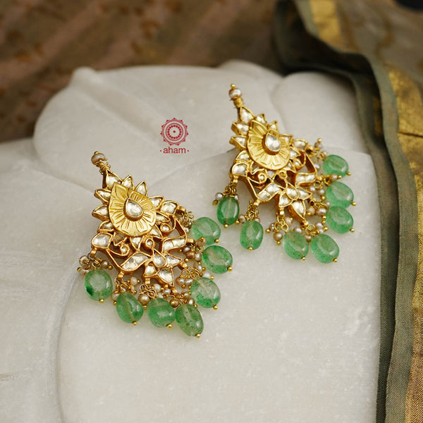 Delicate silver earrings with beautiful kundan work laced with green semi precious stones and pearls. Handcrafted using traditional methods in 92.5 sterling silver and dipped in 22 kt gold polish. Pair these with your ethnic outfits this festive season to ace your look.